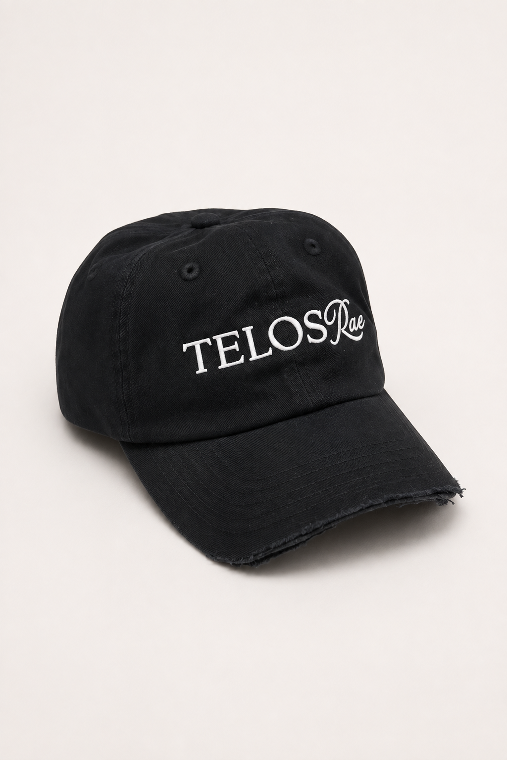Telos Rae Dad Hat in black with cut brim, angled view