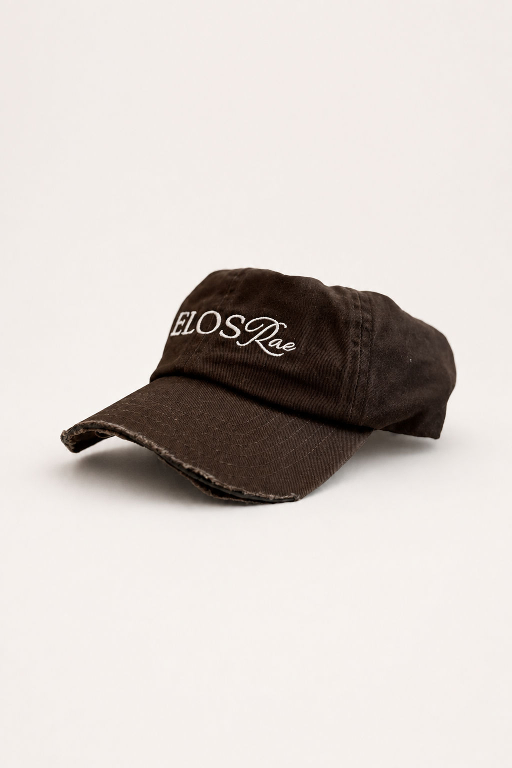 Telos Rae Dad Hat in brown with cut brim, angled view